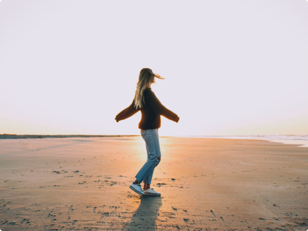 a girl walking oon sand